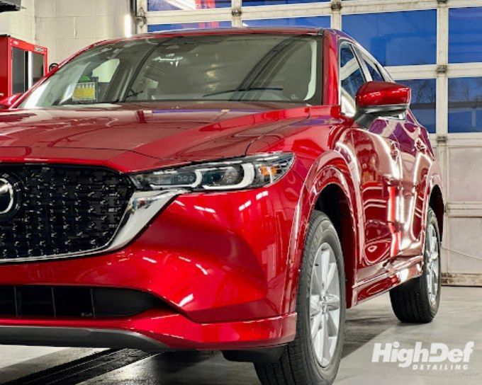 Red Mazda CX-5 SUV in the detailing bay showing paint protection film coverage options