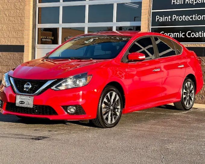 Red Nissan Sentra sedan showing auto window tinting film types for cars