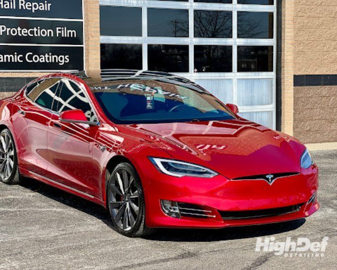 Red Tesla Model S with auto window tinting in Bristol reducing glare and eye strain
