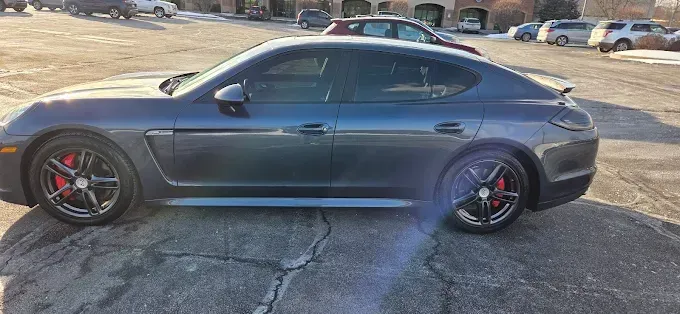 Gray sedan parked outdoors with auto window tinting applied, reducing glare and enhancing privacy. 