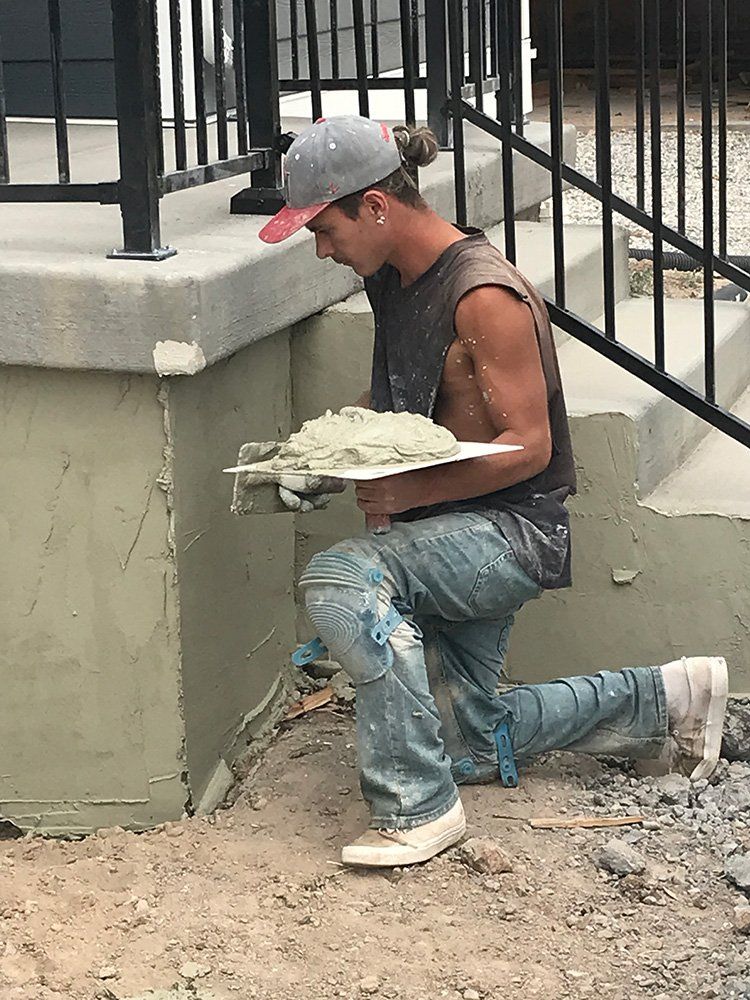 Man Working on House Stair — Layton, UT — H & C Foundation Plastering