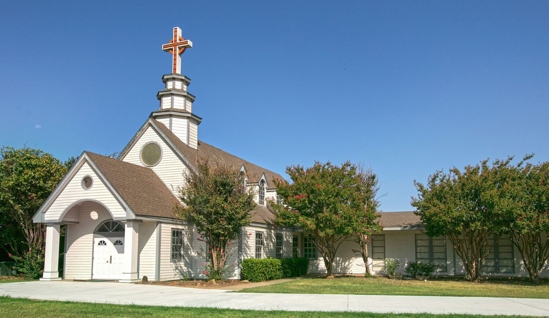 A small church with a cross on top of it