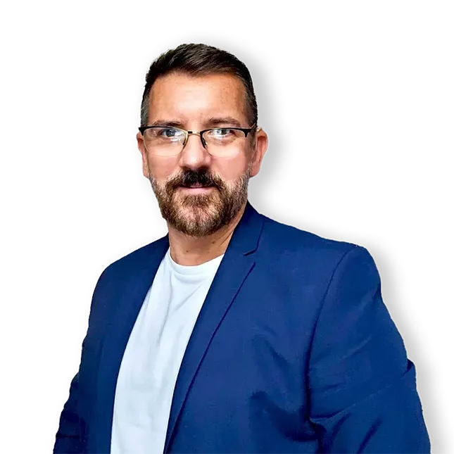 A man with a beard and glasses is wearing a blue suit and white shirt.