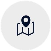 Dark blue map marker on a folded map, within a light gray circle.