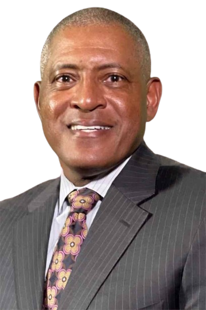Man in a pinstripe suit, smiling, with a patterned tie.