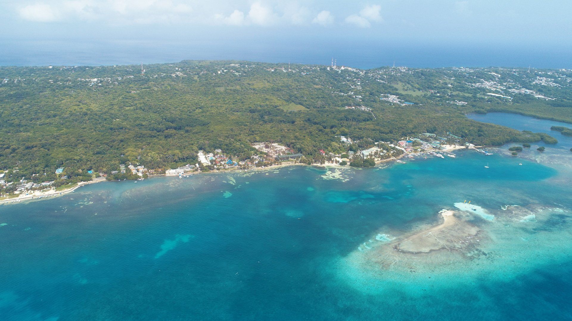 Habitación con cama doble, escritorio y balcón con vista al mar en hotel en San Andrés.