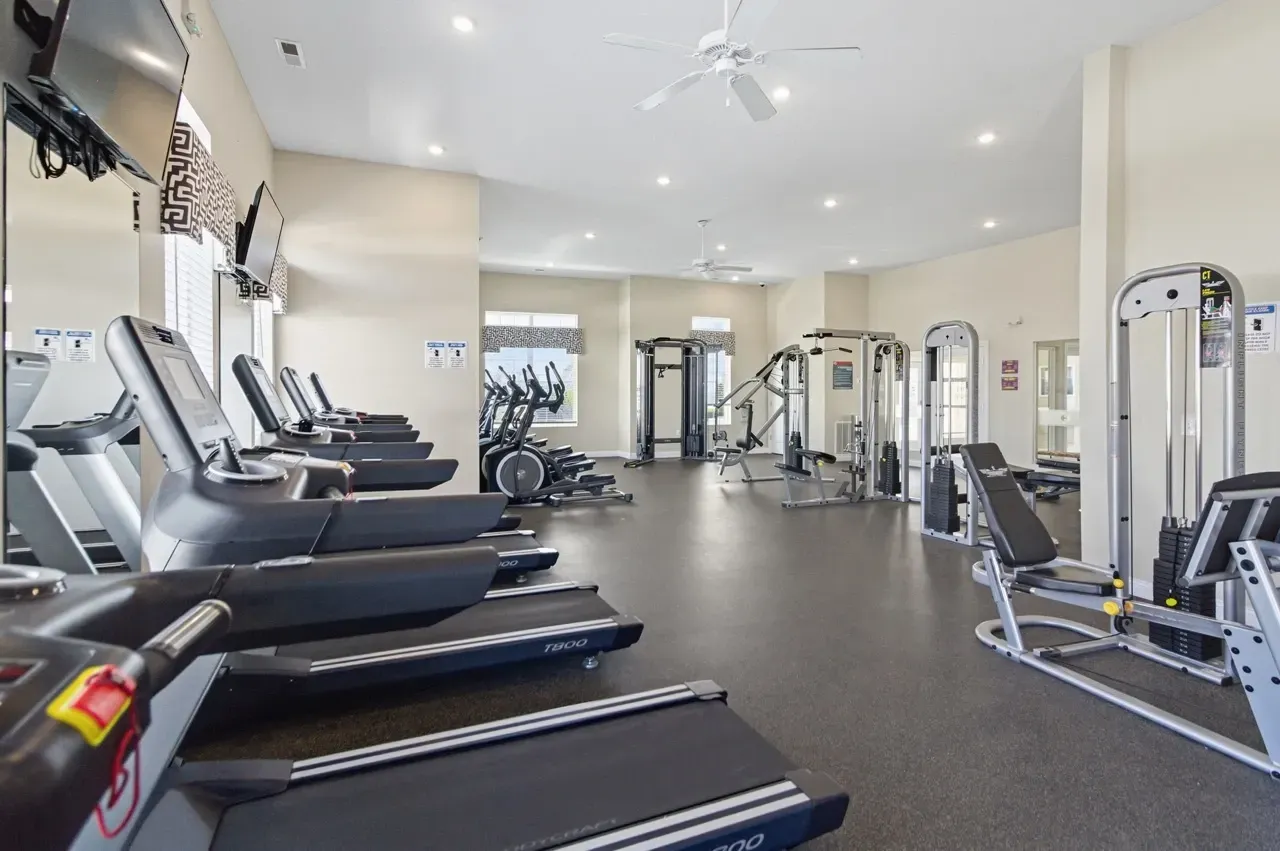 Fitness center with treadmills, ellipticals, and weight machines.