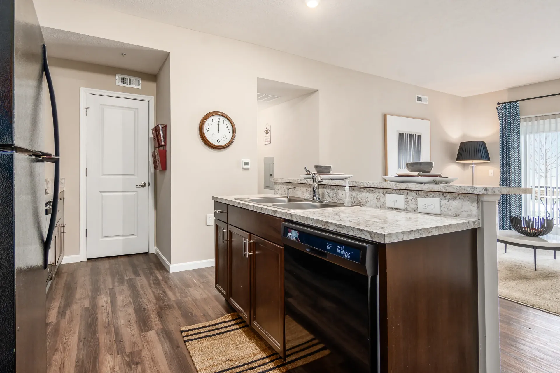 Kitchen with dark wood cabinets, granite countertops, and stainless steel appliances.