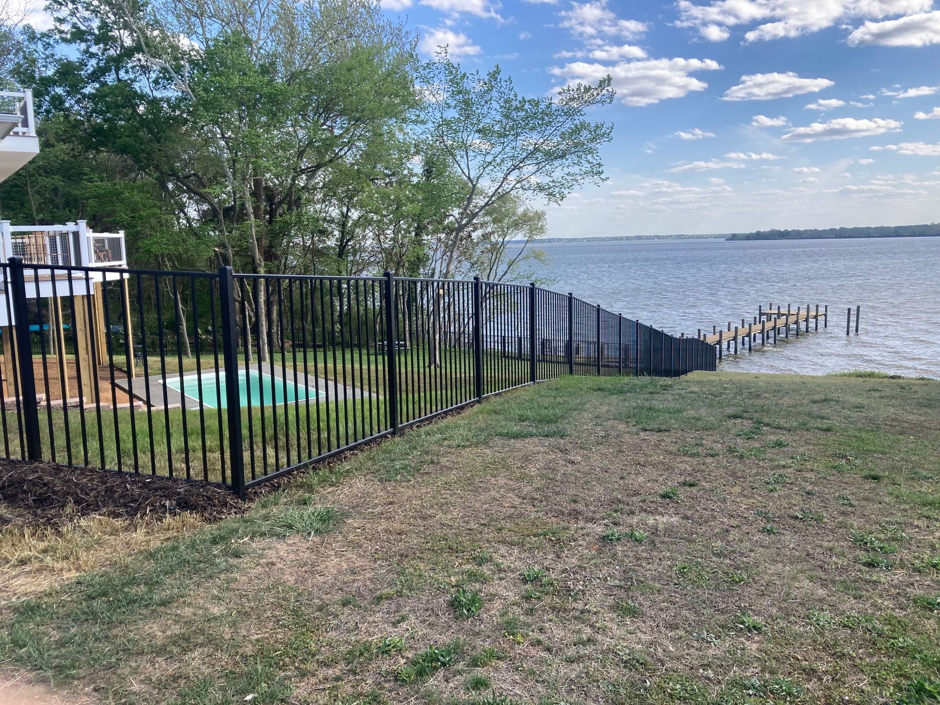Metal fence for waterfront home and around a pool
