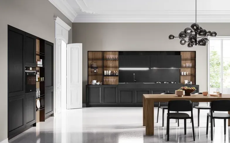 Cucina moderna con mobili neri e dettagli in legno. Tavolo da pranzo e sedie in primo piano.