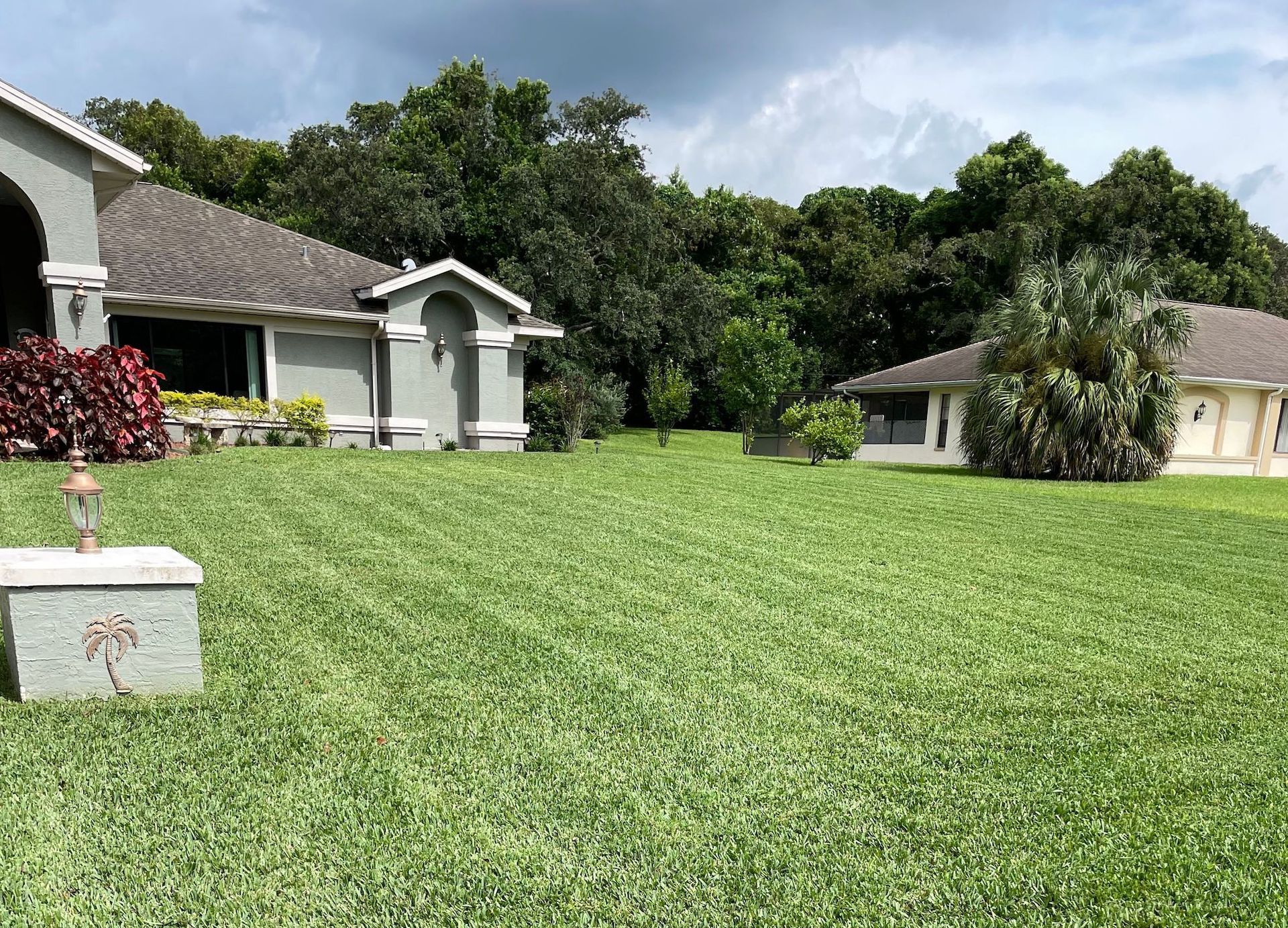A house with a large lawn in front of it