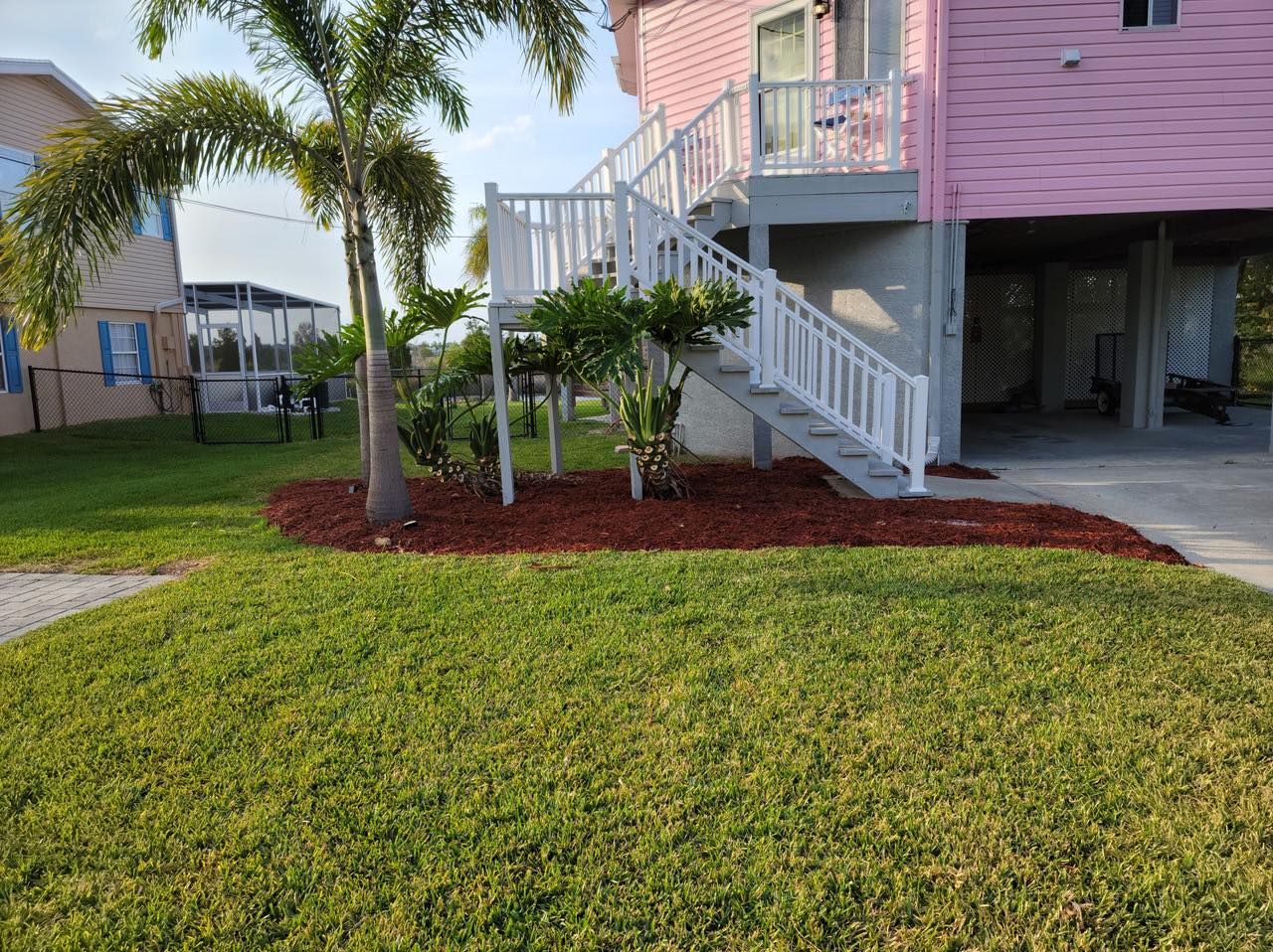 A pink house with stairs leading up to the second floor