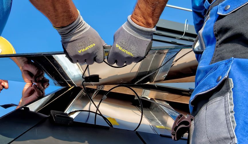 Installer wiring connections on a solar panel
