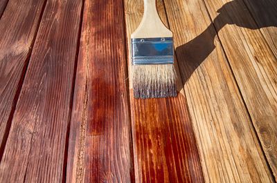 A brush is sitting on top of a wooden table.