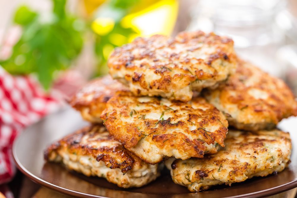 A Plate Of Chicken Patties Stacked On Top Of Each Other On A Table — McGrath Meats In Taree, NSW