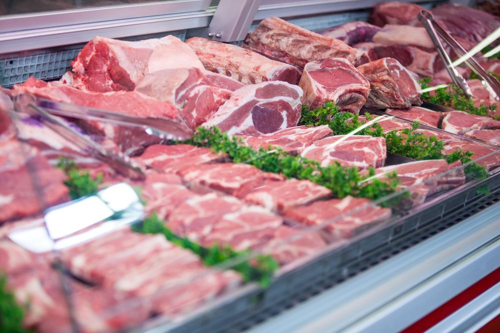 A Display Case Filled With Lots Of Raw Meat In A Butcher Shop — McGrath Meats In Taree, NSW