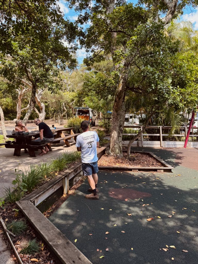 A man is walking down a path in a park — Lennox Head Tree Care In Lennox Head, NSW