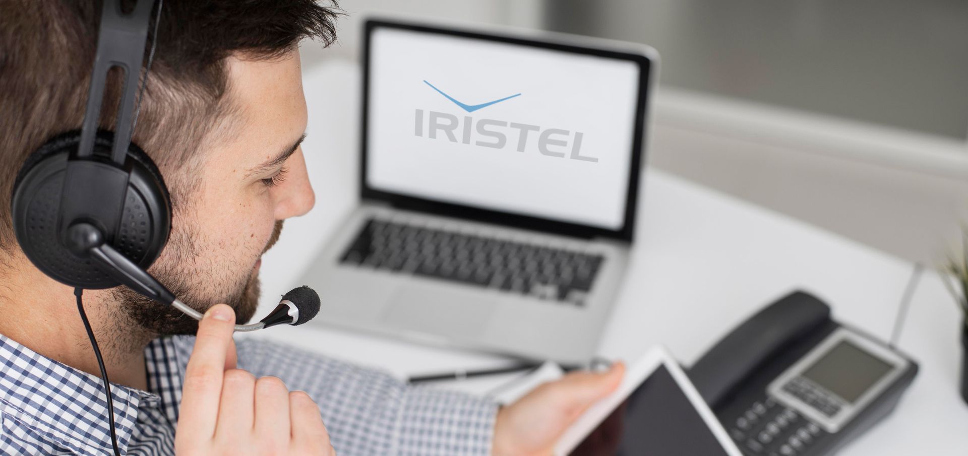 man wearing headphones and using a laptop