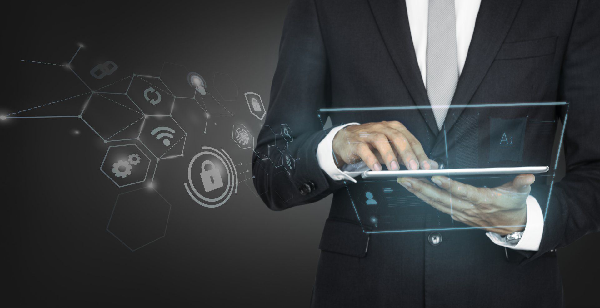 A man in a suit and tie is using a tablet computer.