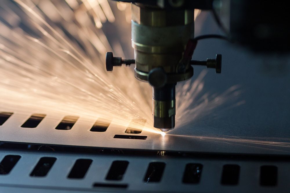 A Machine Is Cutting a Piece of Metal with A Lot of Sparks — Advanced Poly in Yarrawonga, NT