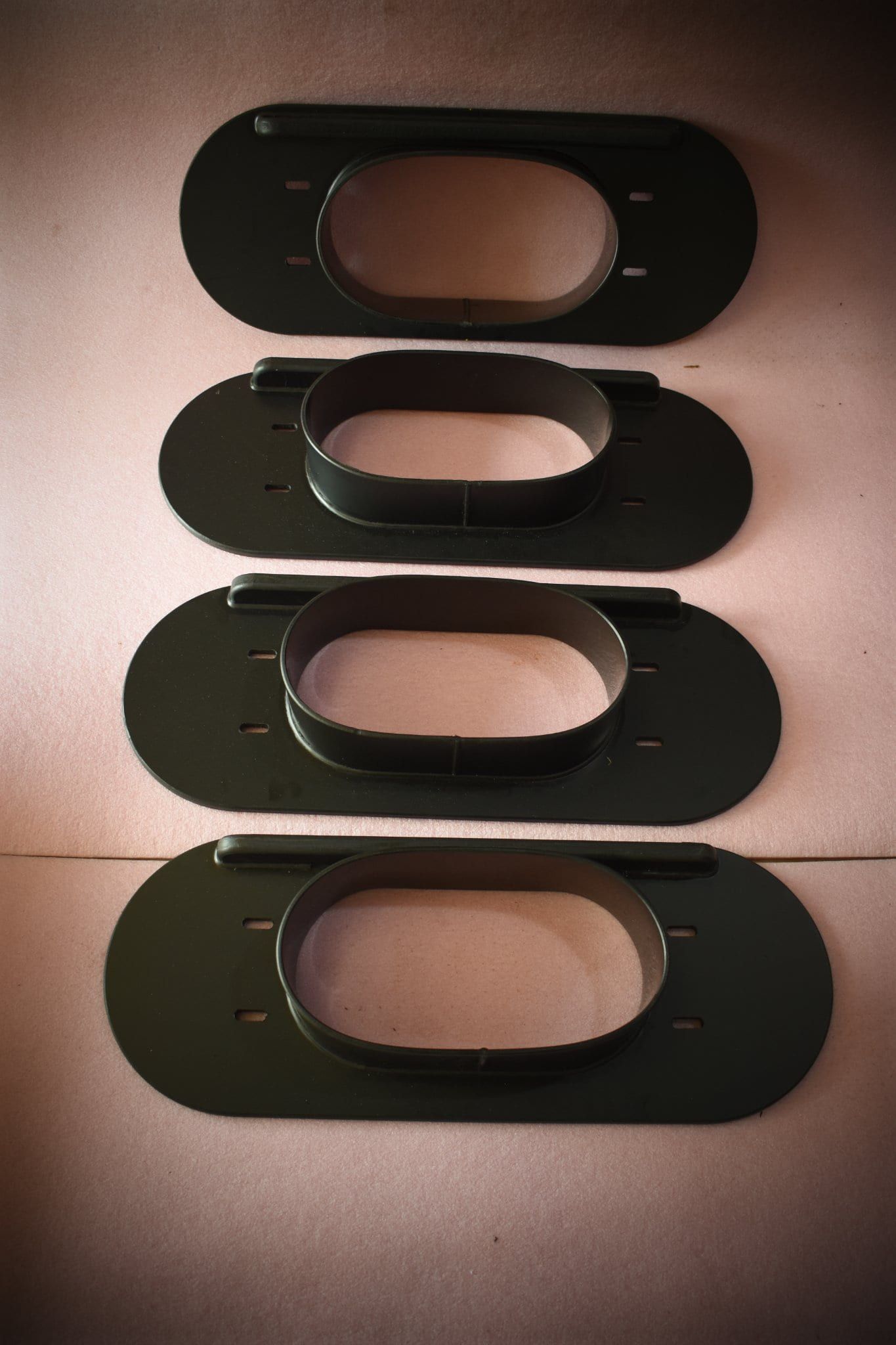A row of black plates with oval holes in them — Advanced Poly in Yarrawonga, NT