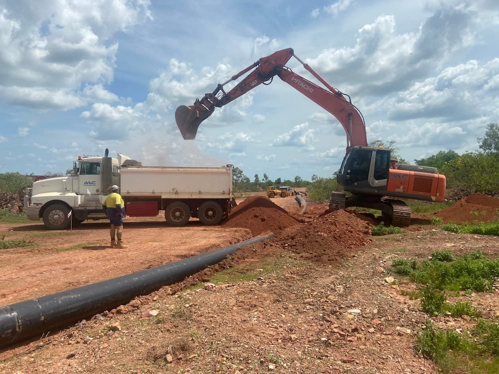 An Excavator Is Loading Dirt Into a Dump Truck — Advanced Poly in Yarrawonga, NT