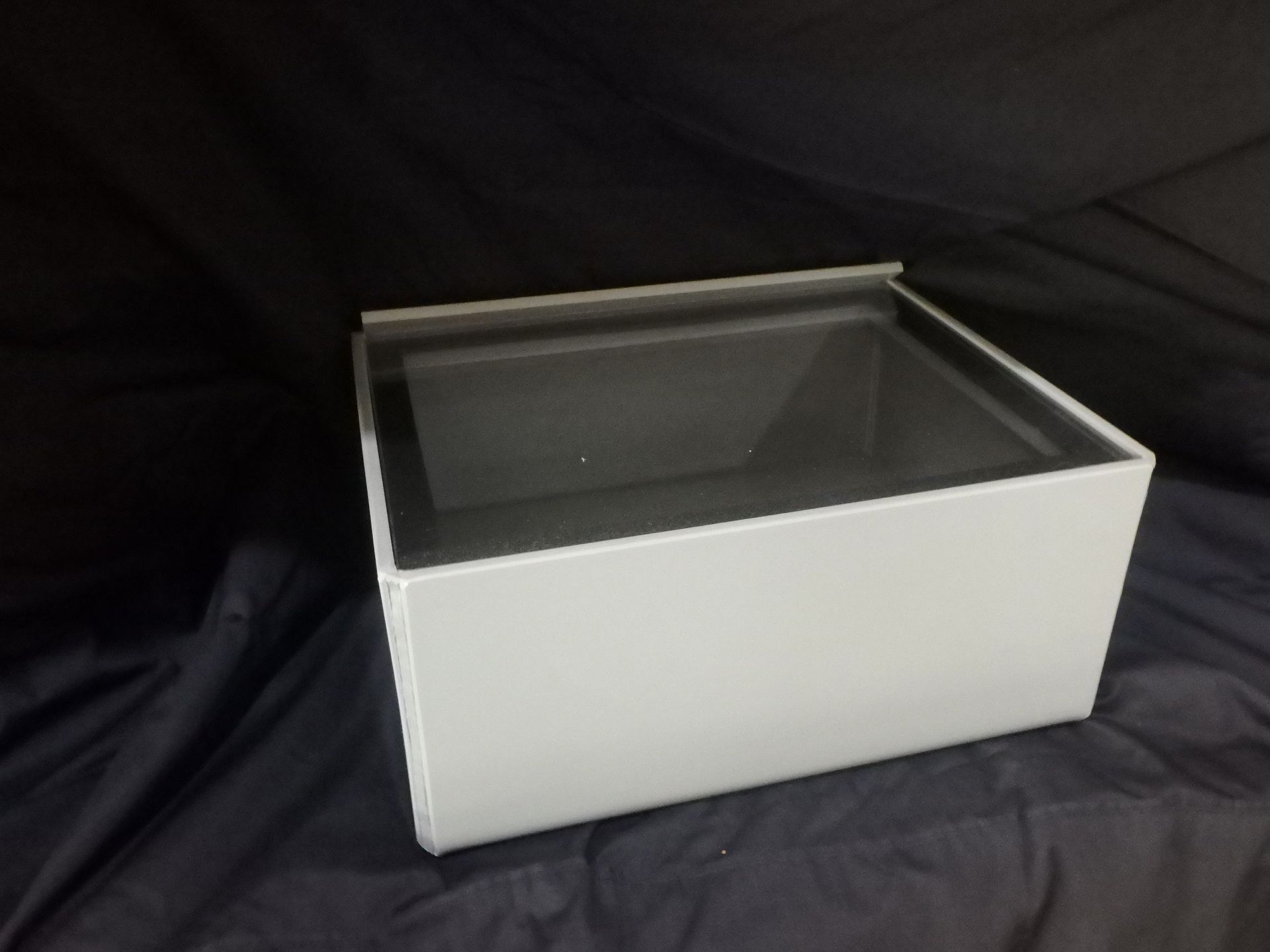 White display case with a glass top on a dark background — Advanced Poly in Darwin, NT — Advanced Poly in Darwin, NT 