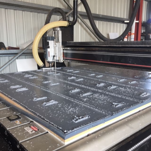 CNC router engraving white lettering on a dark sheet in a workshop — Advanced Poly in Darwin, NT — Advanced Poly in Darwin, NT 