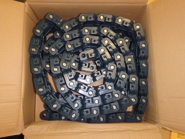 Box filled with coiled black metal chains or straps stacked inside a cardboard carton — Advanced Poly in Darwin, NT 