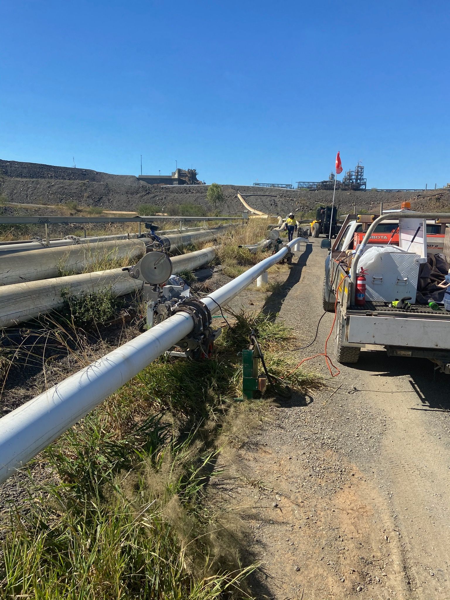 Workers repairing guardrail along a rural roadside, with utility vehicles and blue sky. — Advanced Poly in Darwin, NT