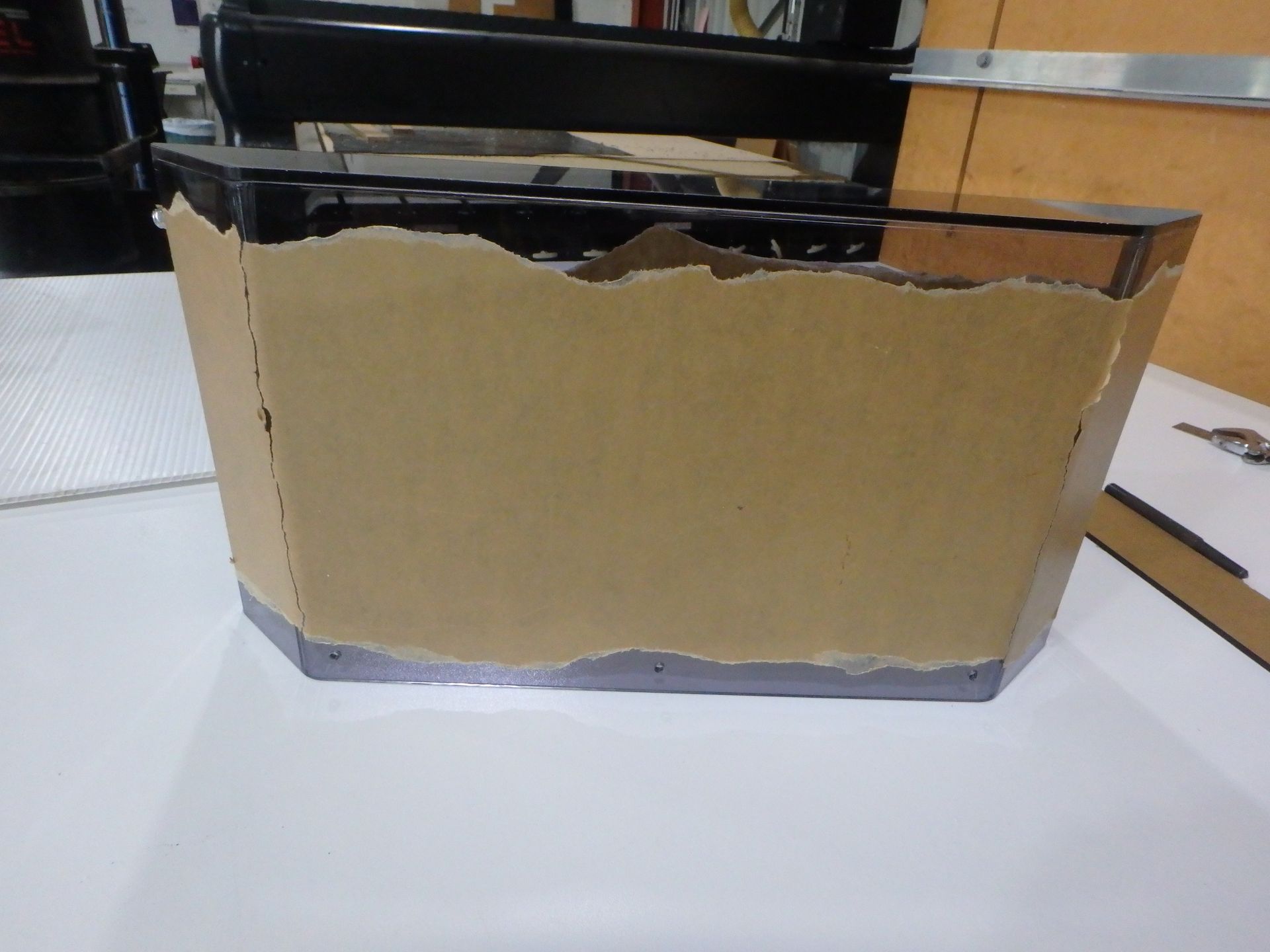 Cardboard box with black tape on a white table in an office setting — Advanced Poly in Darwin, NT — Advanced Poly in Darwin, NT 