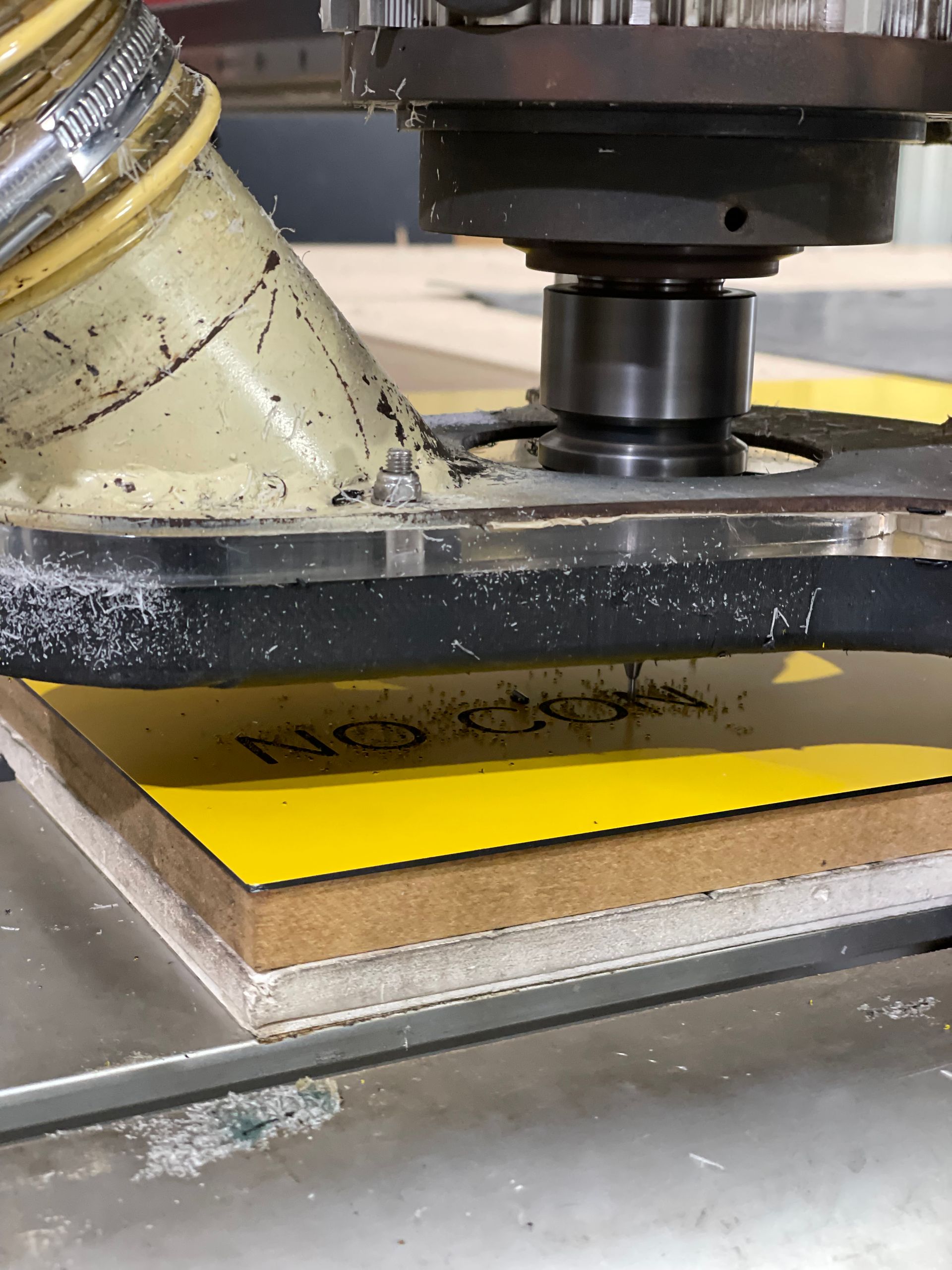 Industrial machine cutting a bright yellow sheet on a metal worktable — Advanced Poly in Darwin, NT