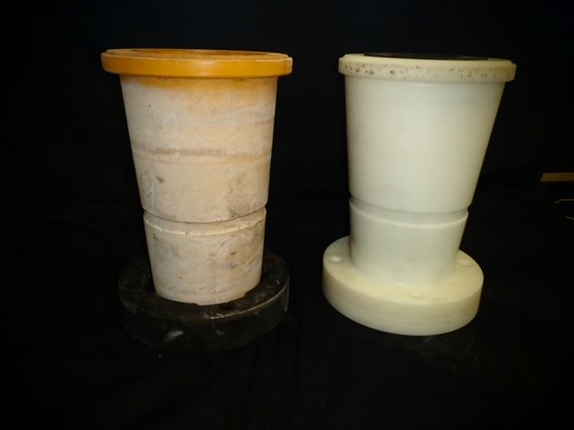 Two stacked plastic containers, one beige with an orange rim and one white, on a dark surface. — Advanced Poly in Darwin, NT