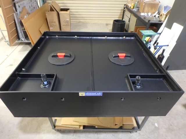 Large black metal equipment case with four red-latched compartments in a workshop setting — Advanced Poly in Darwin, NT
