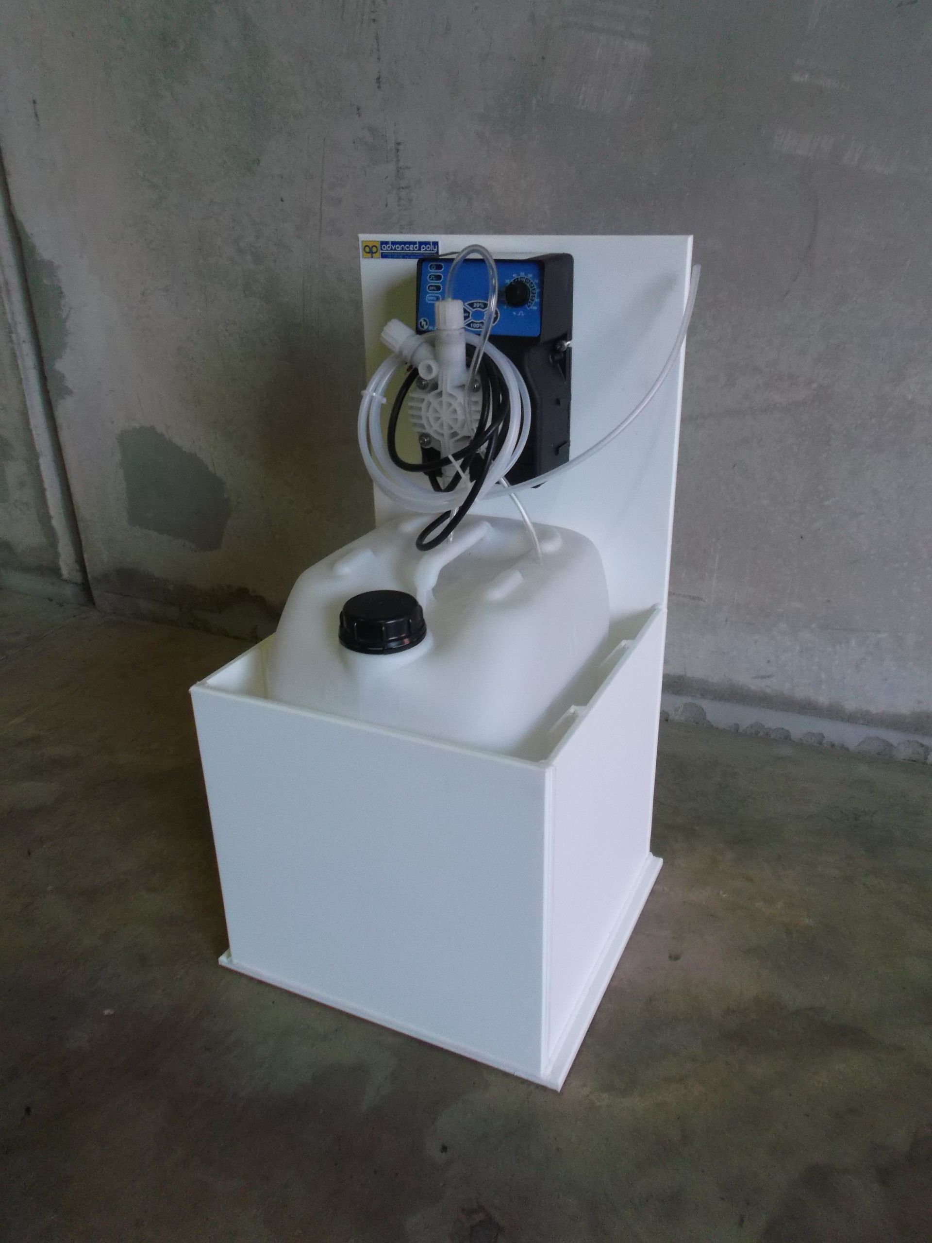 White sink unit with a blue wall-mounted control panel and coiled hose in a concrete room — Advanced Poly in Darwin, NT