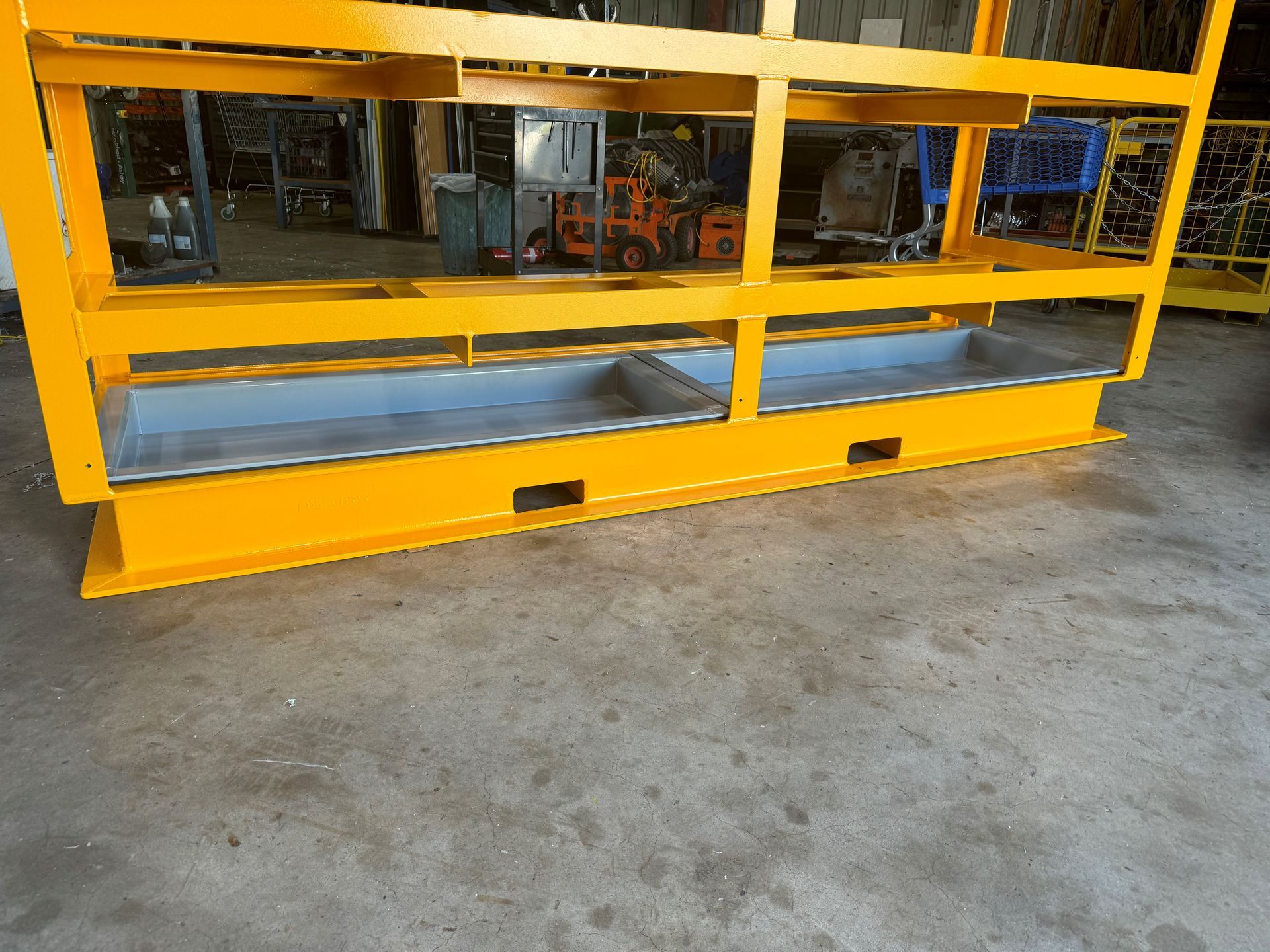 Yellow industrial safety barrier with metal shelves in a warehouse setting — Advanced Poly in Darwin, NT 