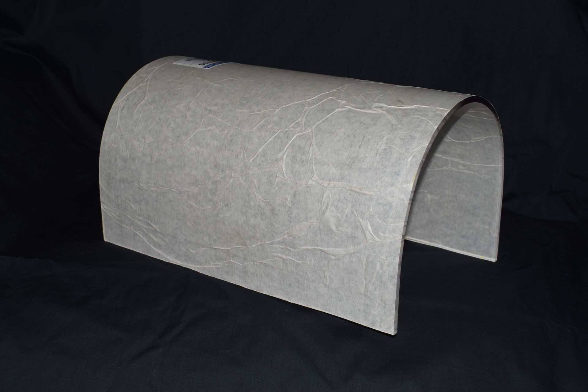 Gray curved felt tunnel or pet bed on a black background — Advanced Poly in Darwin, NT 