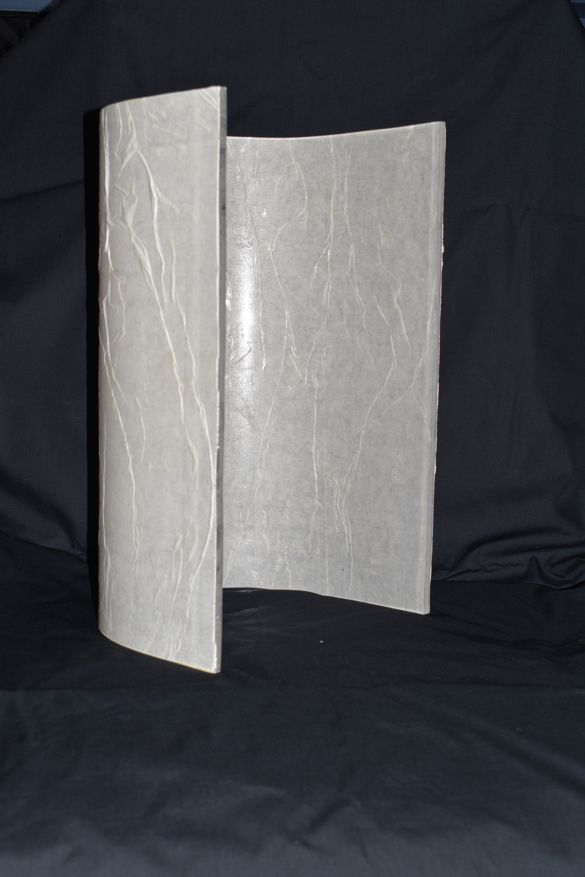 Open gray folding divider with a textured surface against a dark background — Advanced Poly in Darwin, NT 