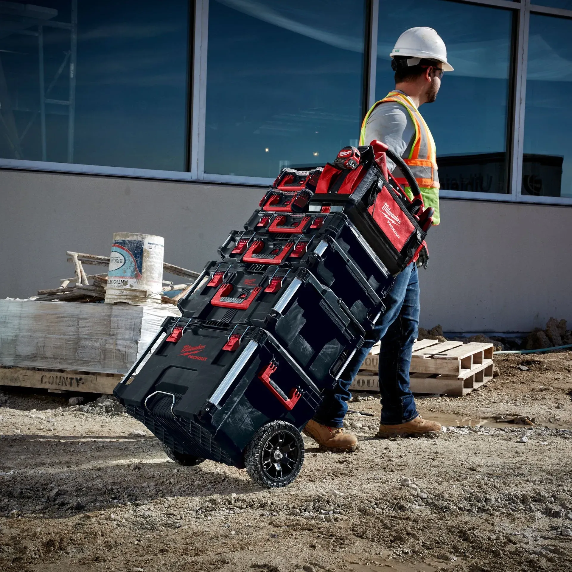 A Construction Worker is Carrying a Stack of Tool Boxes on a Cart — FarmCare in Mullumbimby, NSW