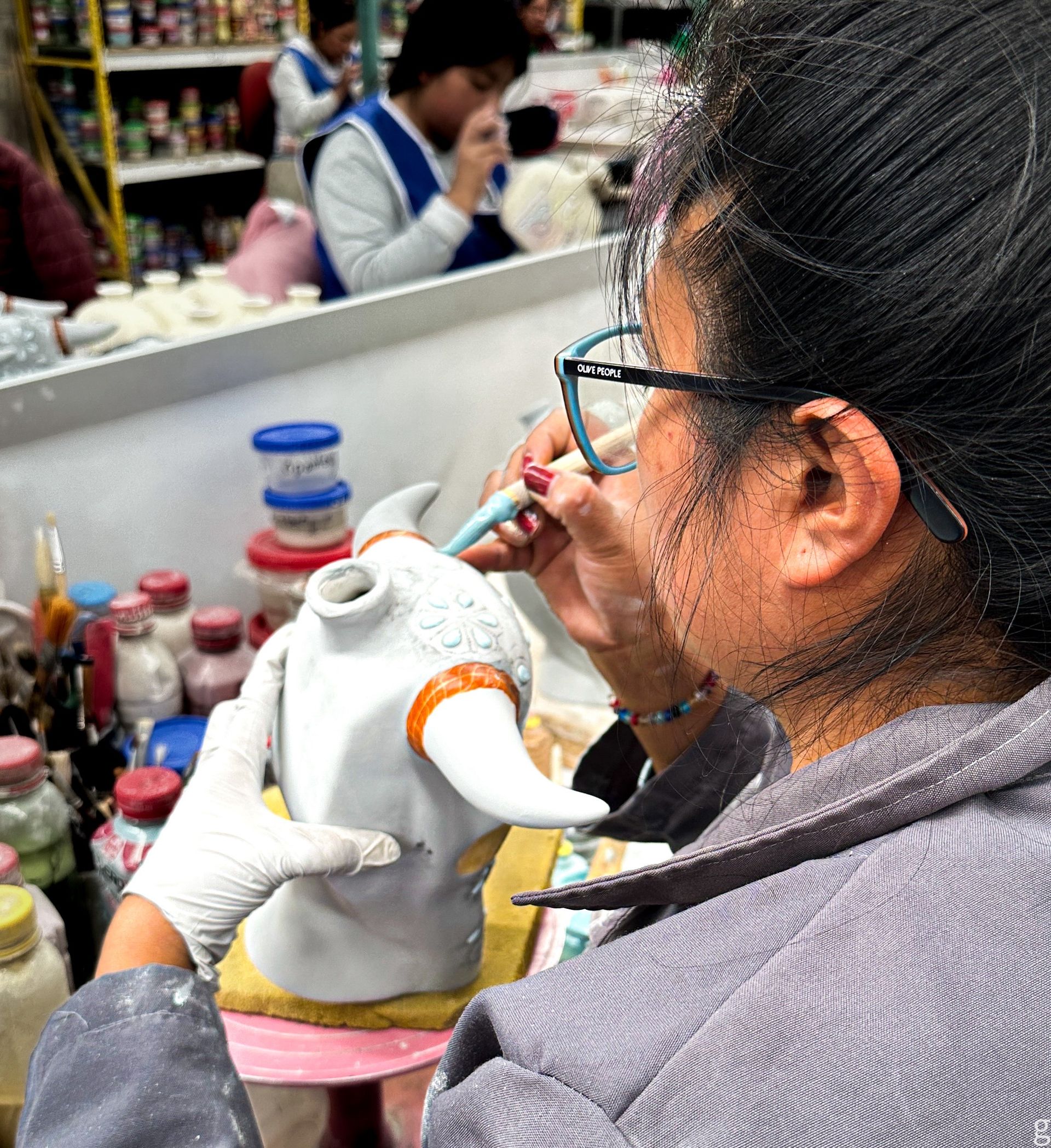 mexican artisan handpainting bottle