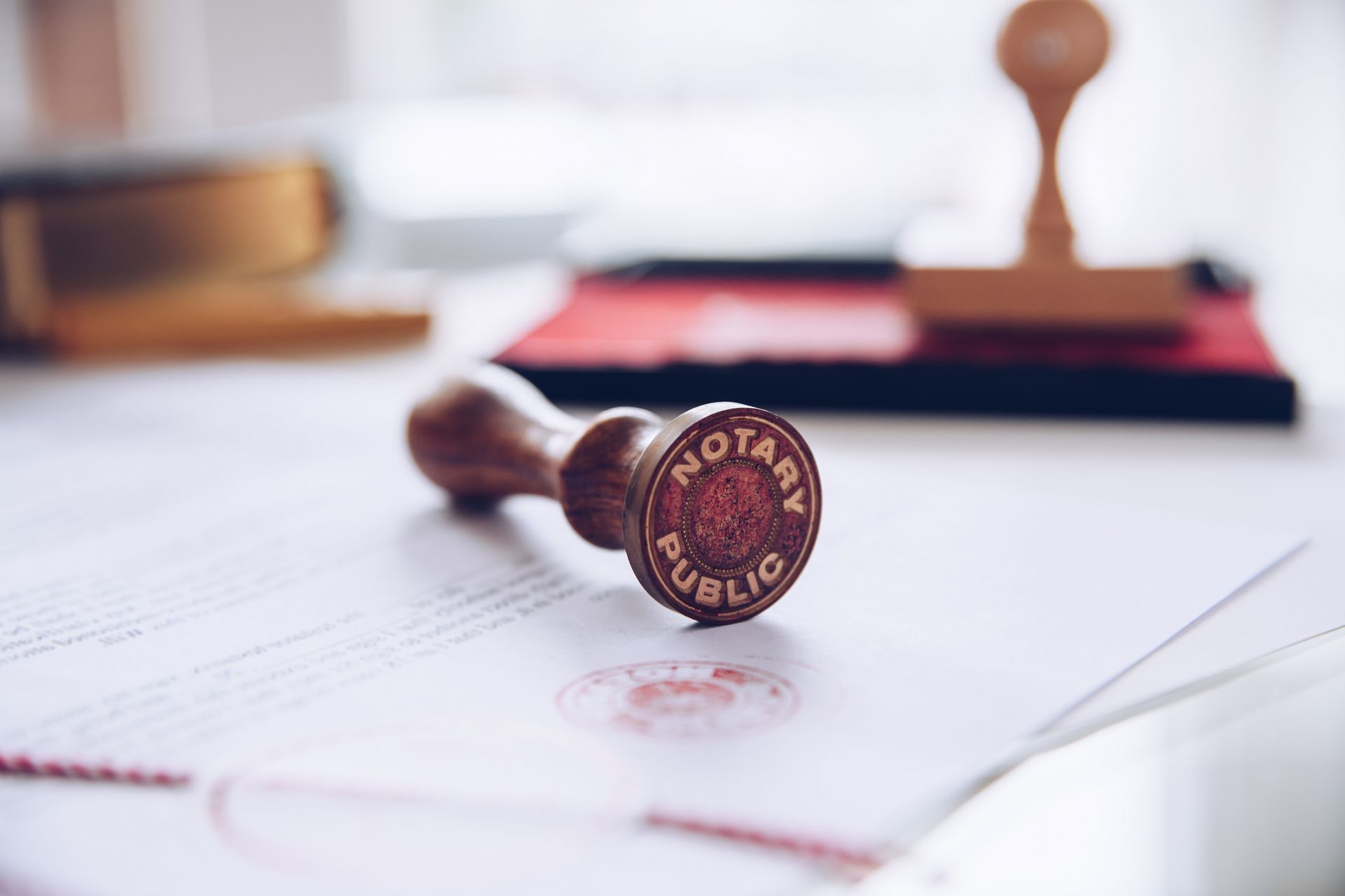 Notary public stamp on a document with red ink