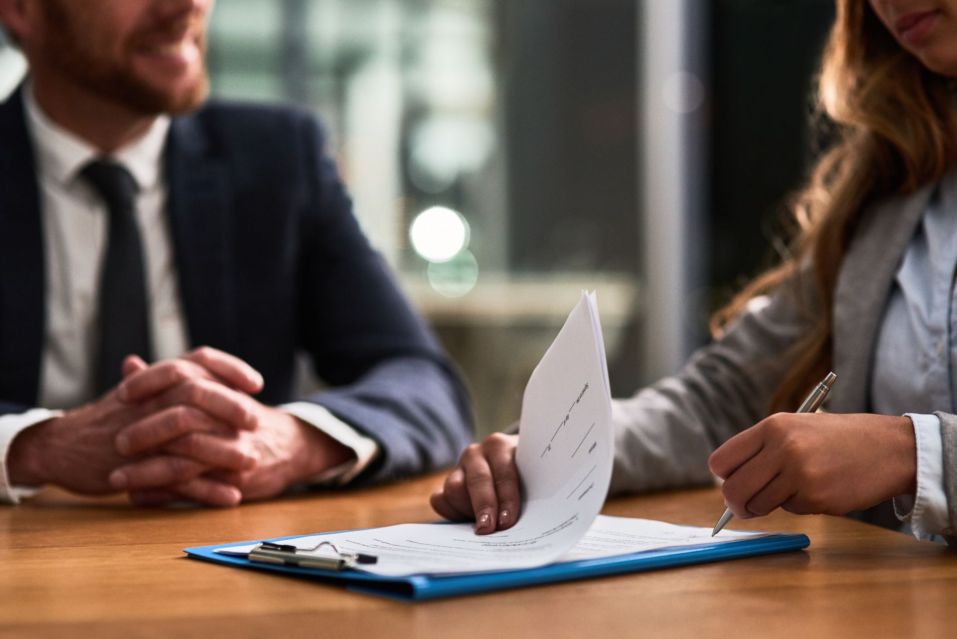 Woman signing a document