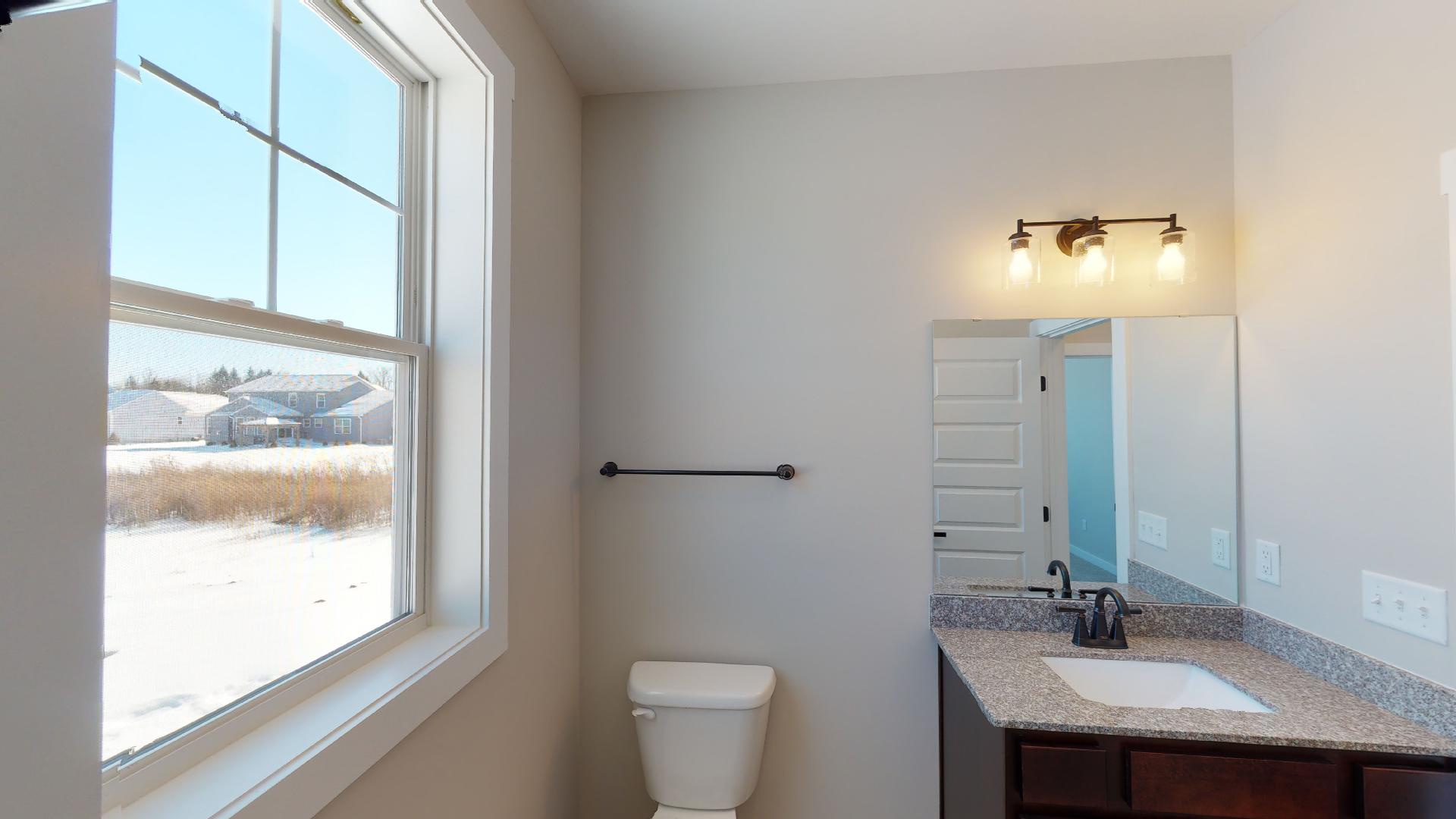 half bathroom toilet next to vanity