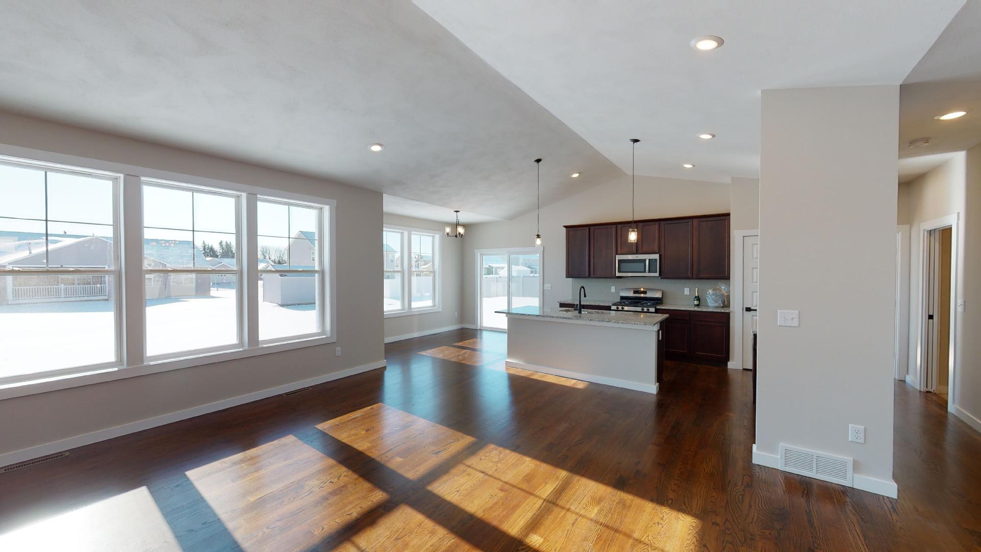 living room and kitchen with vaulted ceilings