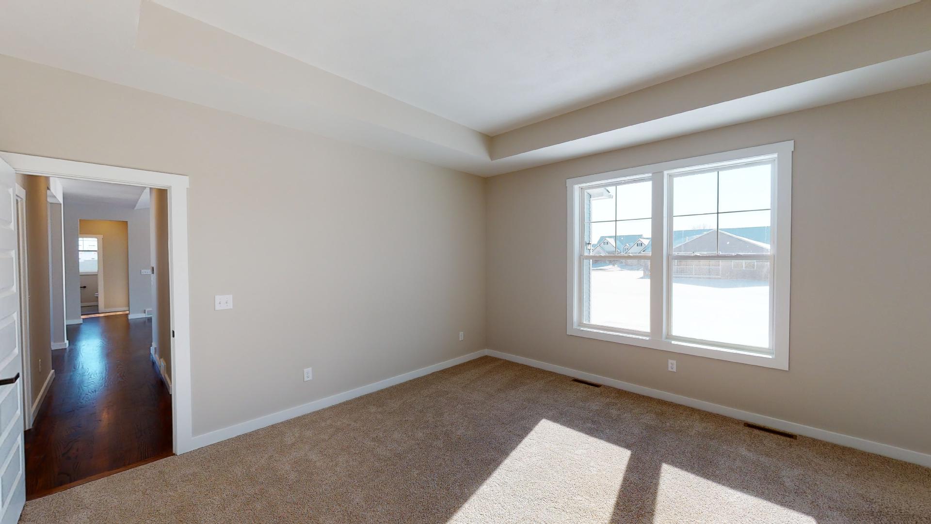 primary bedroom with vaulted ceilings