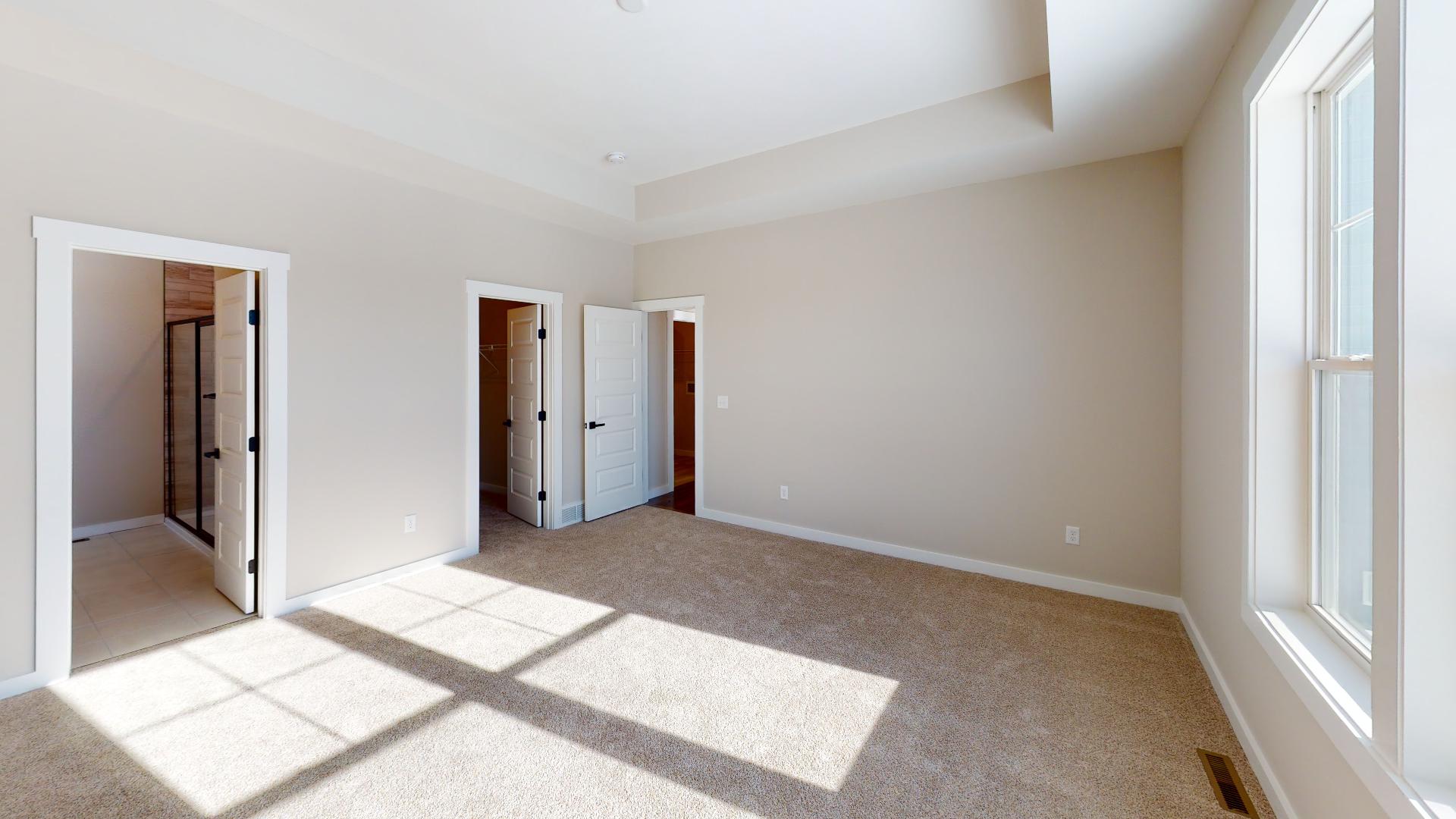 primary bedroom with recessed ceiling