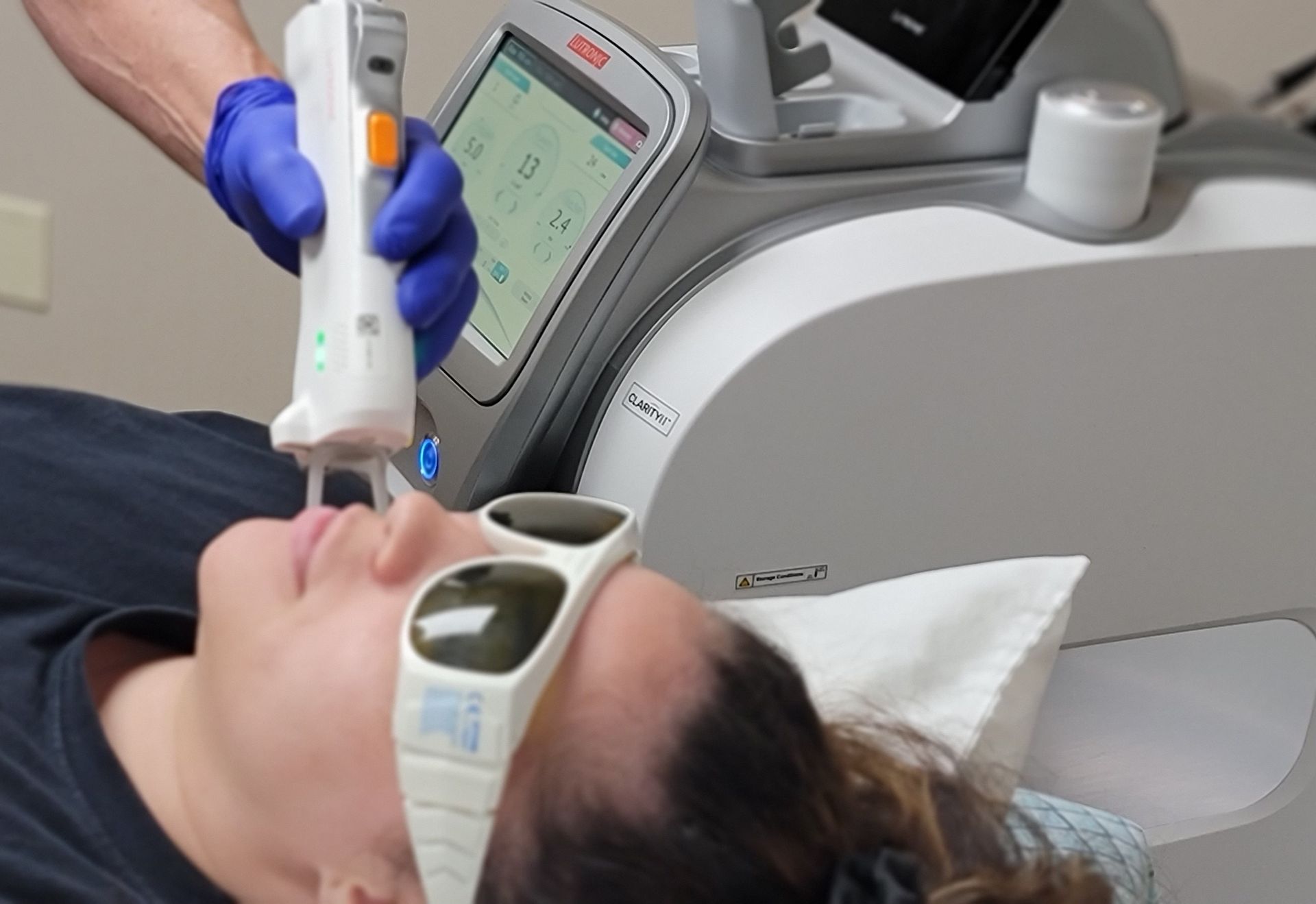 A woman is getting a laser hair removal treatment on her arm.