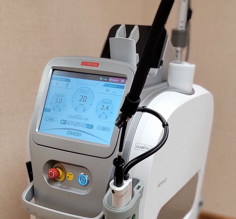 A man is getting a laser treatment on his face.