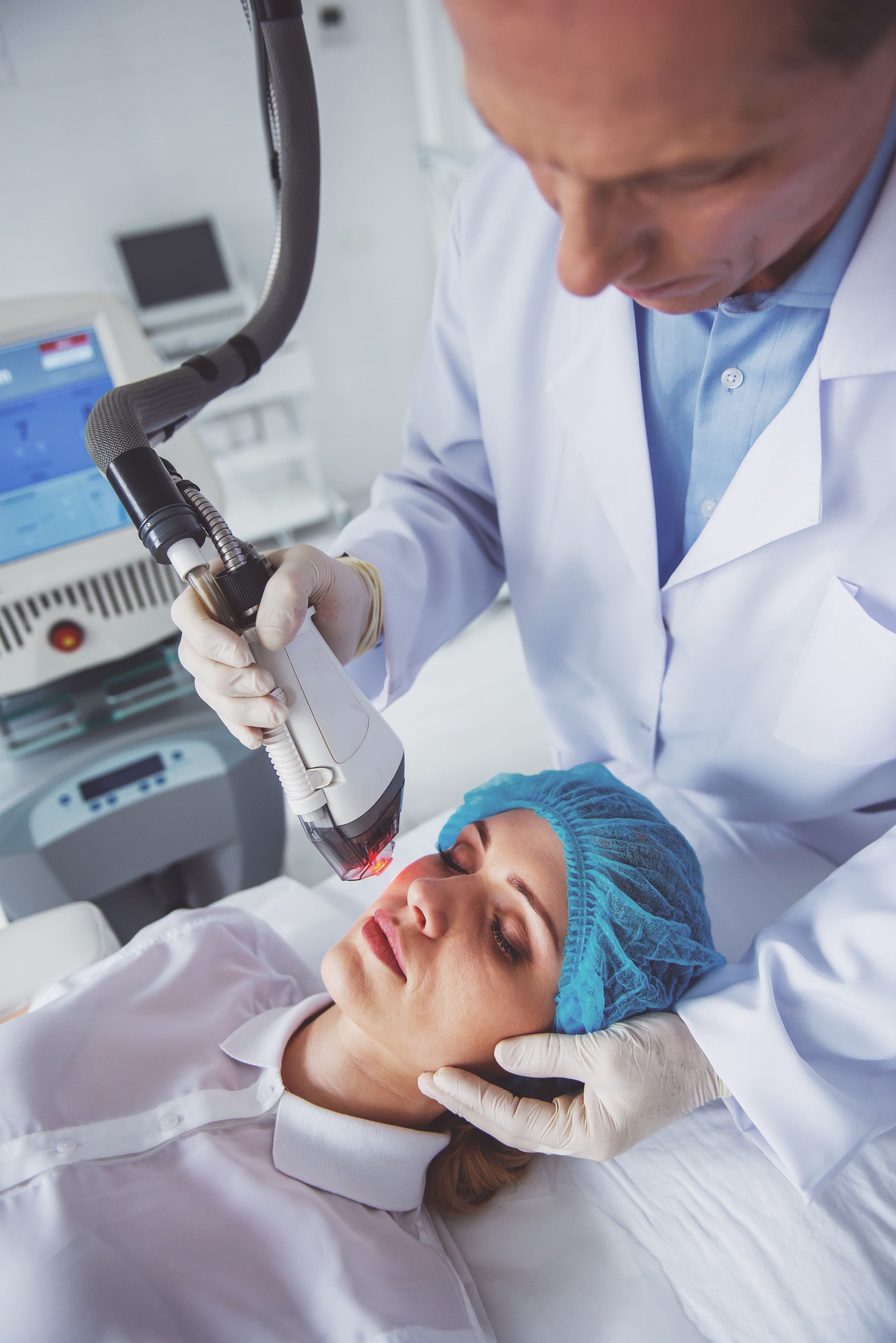 A woman is getting a laser treatment on her face.