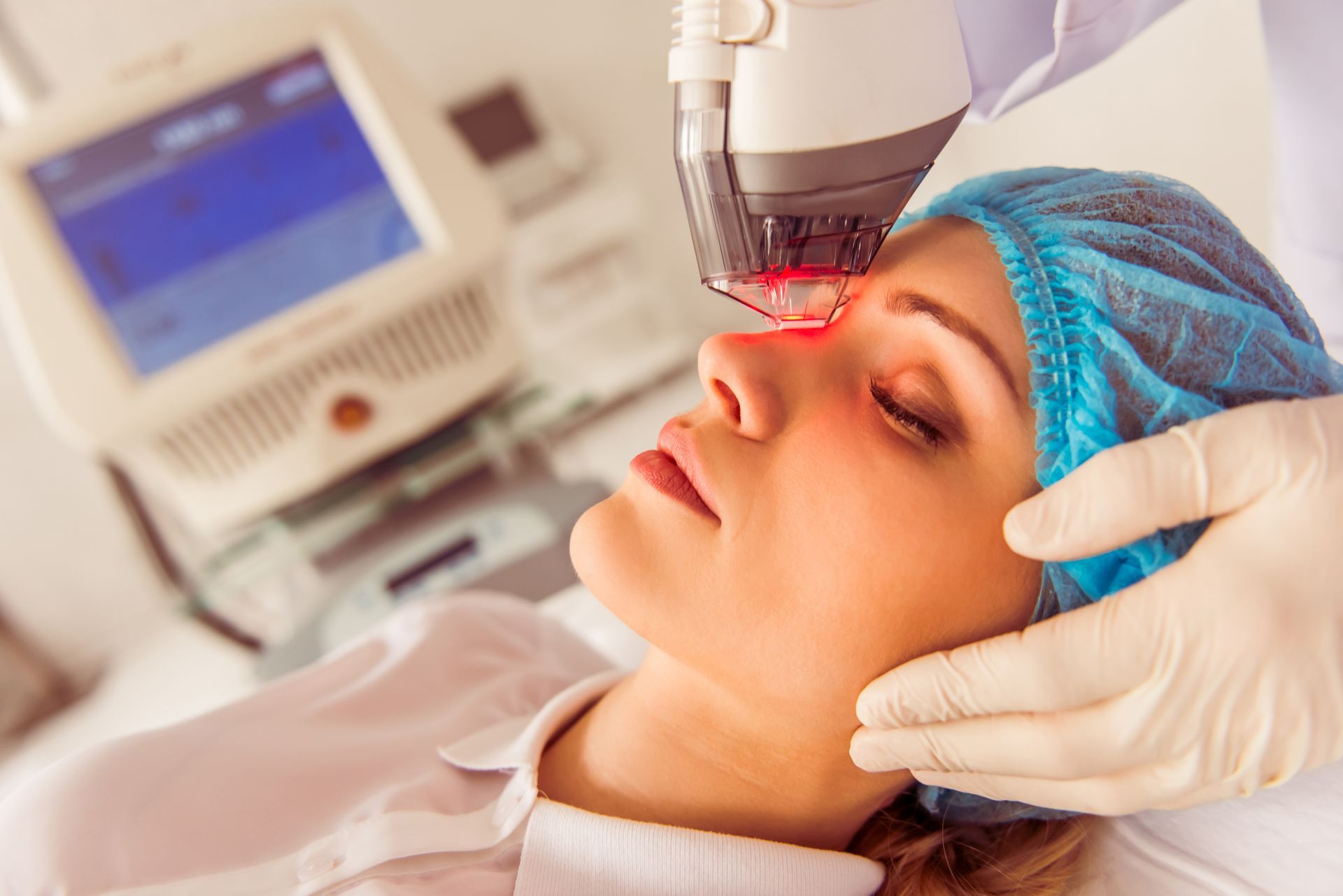 A woman is getting a laser treatment on her face.